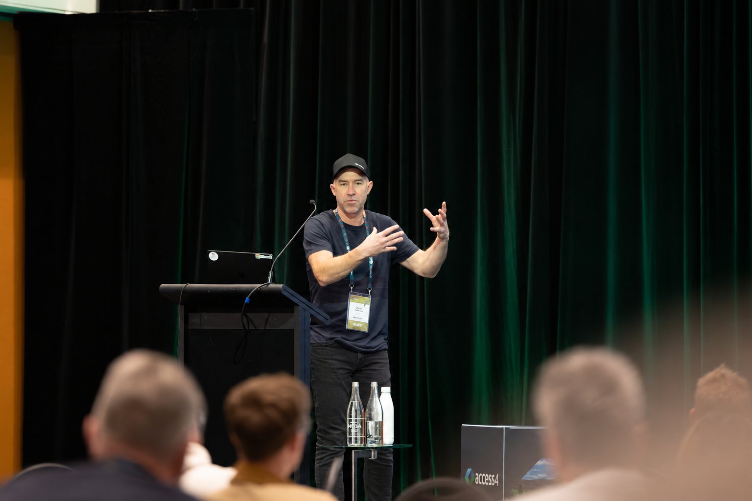 Daniel Anderson explaining a point to the audience from the lectern at the Access4 annual conference